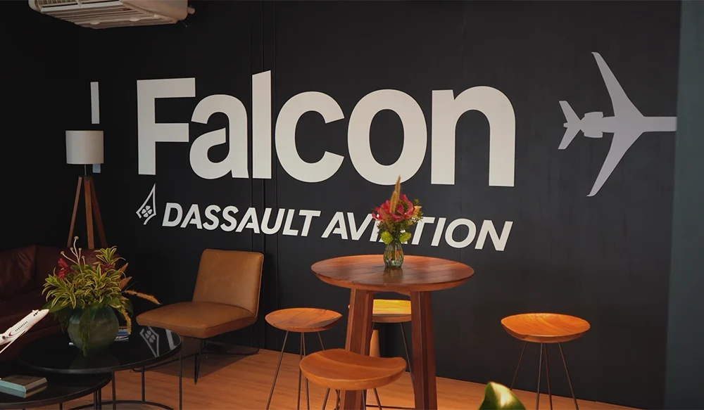 Foto de uma parede preta com o logo da Falcon - Dassault Aviation